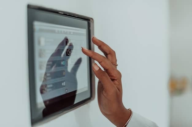 A close-up shot of a smart home security panel with a person's hand interacting with the touch screen. The screen displays options for arming and disarming the system, viewing camera feeds, and controlling smart home devices.