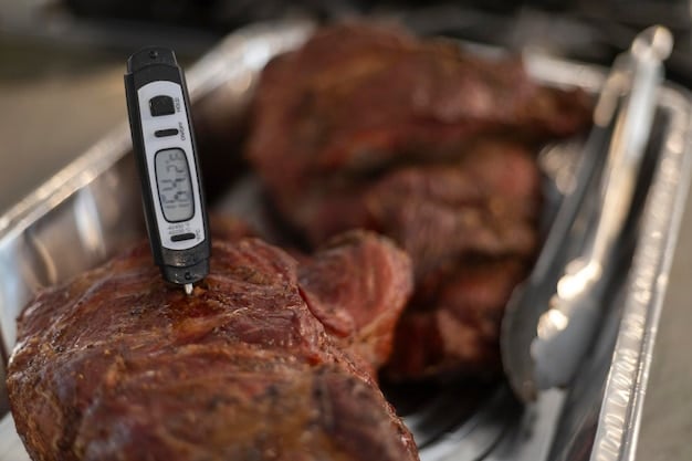 A close-up shot of a digital thermometer reading the internal temperature of a piece of meat inside a refrigerator.