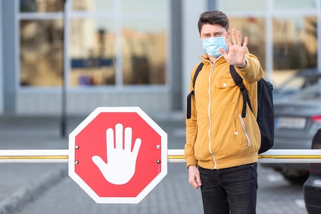 A close-up shot of a school crossing guard's hand holding a stop sign, with a blurred background of passing cars and school children. The focus is on the sign and the guard's hand, emphasizing their authority and responsibility.