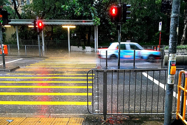 A police car parked near a school zone with its lights flashing, indicating active enforcement of traffic laws.