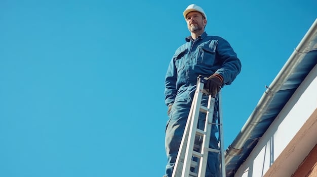 Home inspector on a ladder examining the roof of a house, safety harness, blue sky in the background, residential neighborhood visible.