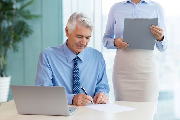 A senior carefully reviewing documents with a mortgage advisor in a bright, professional office setting.
