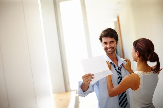 A real estate agent handing a pre-approval letter to a prospective home buyer.