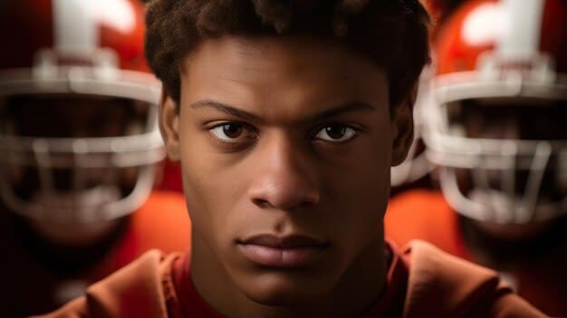 A close-up shot of a young football player on the sidelines, looking dazed and being attended to by a coach or medical staff member. The image conveys concern and the importance of immediate attention to potential concussions.