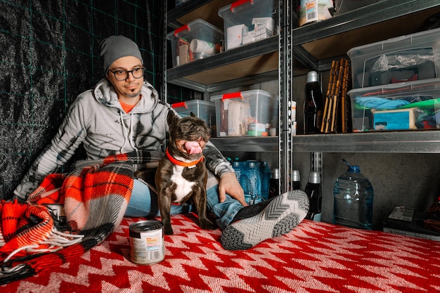 A close-up shot of a parent meticulously cleaning and organizing hockey equipment in a garage, surrounded by bags, helmets, and pads. The lighting is soft and emphasizes the time and effort involved in maintaining the gear, highlighting the parental commitment to their child's hockey aspirations.
