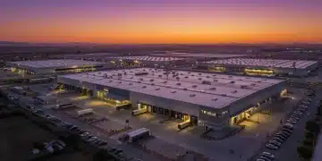Mercado de Naves Industriales en España: Auge del 15% en Demanda Parque industrial moderno al atardecer en España con naves logísticas y camiones activos, reflejando el dinamismo del sector.